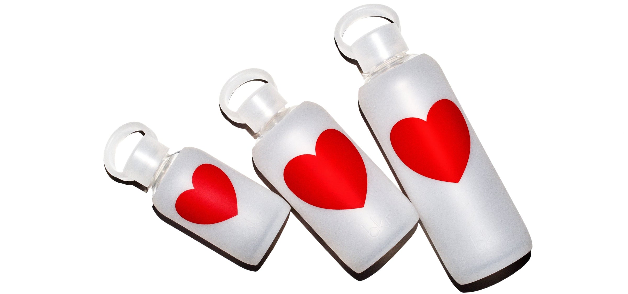 Reusable glass and silicone water bottles in Sheer Frost with red heart print.
