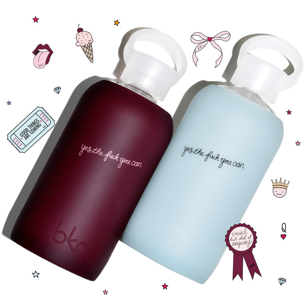 Reusable glass and silicone water bottles in demi sheer deep vampy blood burgundy and sheer sheer glacial milk blue with "yes the fuck you can" print.