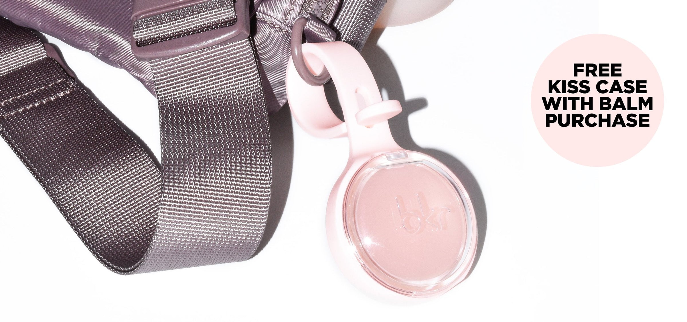 bkr lip balm compact in silicone compact carrying case attached to bag.