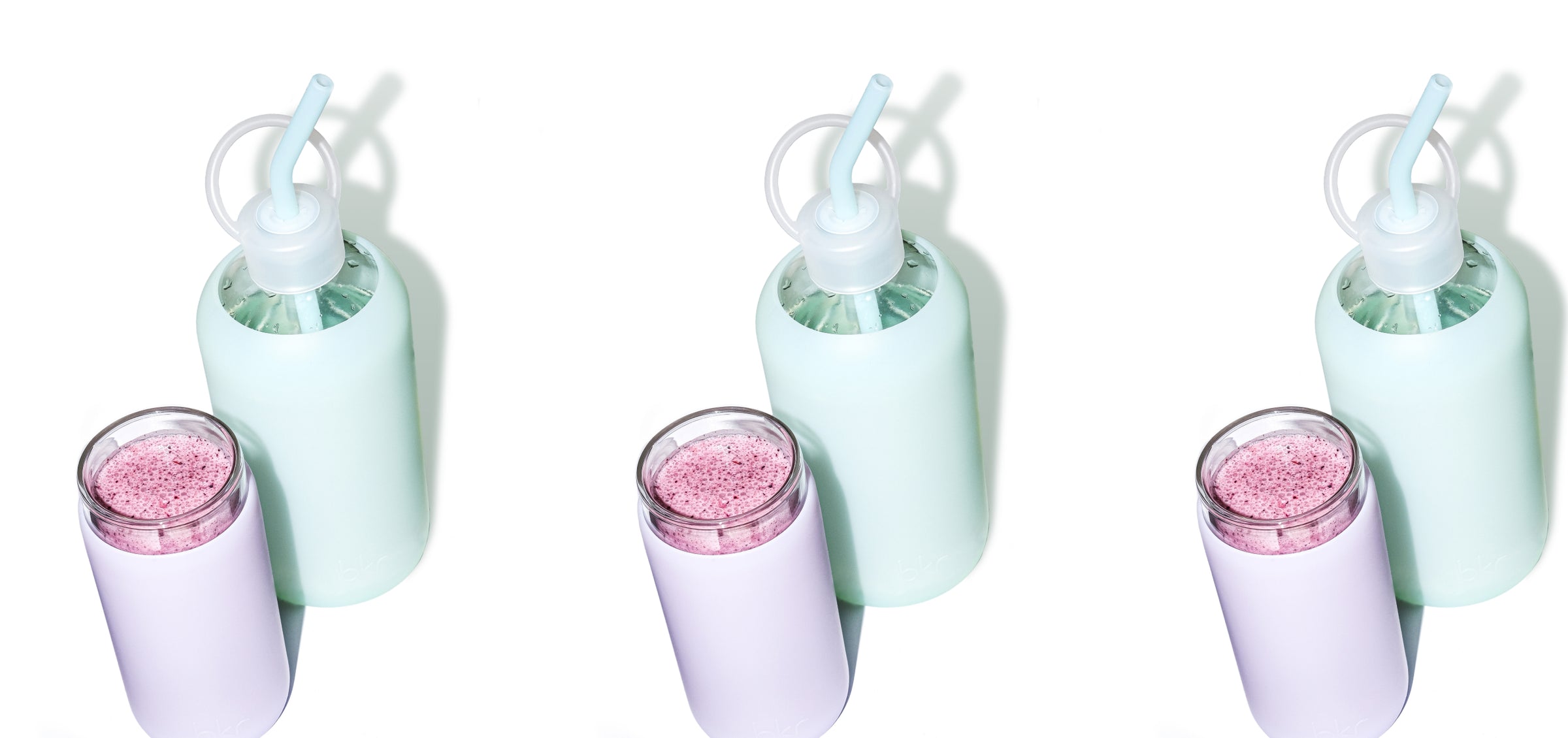 Reusable glass and silicone water bottle and insulated cup in opaque soft sage green and sheer misty lilac.