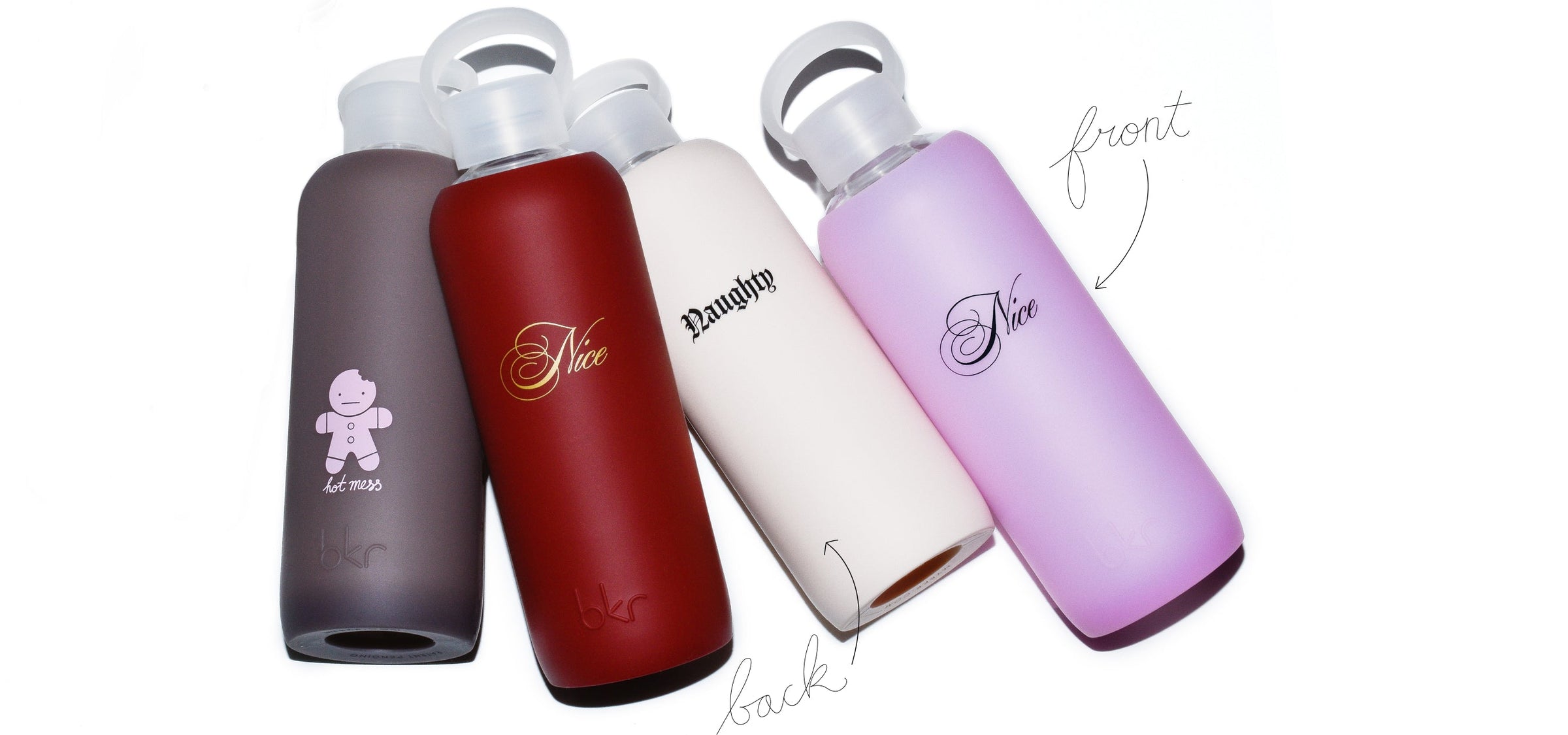 holiday limited edition bkr glass and silicone reusable water bottles in sheer malt coco brown with pink gingerbread hot mess print, opaque venice brick red with gold naughty or nice print, opaque linen with black naughty or nice print, and sheer pastel neon pink with black naughty or nice print. 