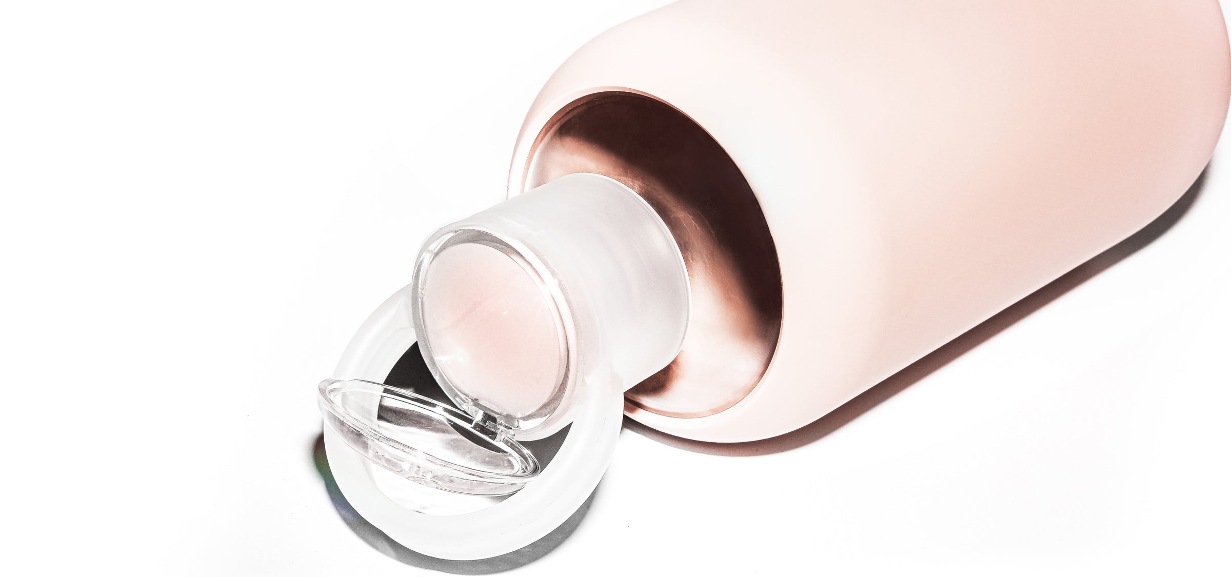 Glass & silicone lip balm water bottle in opaque ballet pale peachy pink.