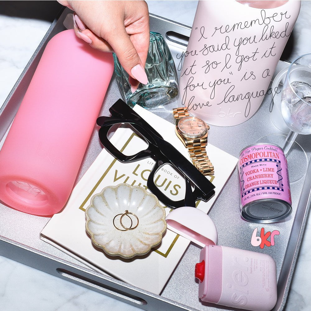 bkr glass and silicone reusable water bottles in sheer sugary warm pink and opaque ballet pale peachy pink.