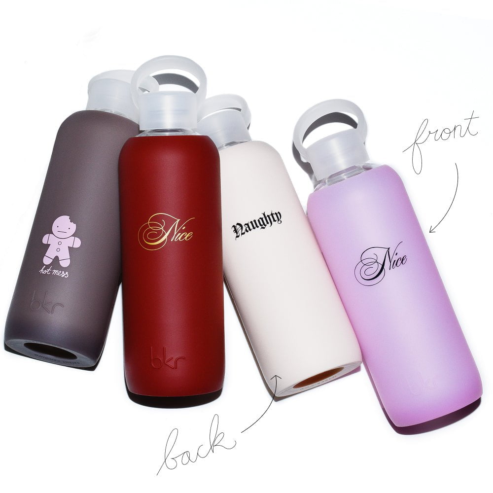 holiday limited edition bkr glass and silicone reusable water bottles in sheer malt coco brown with pink gingerbread hot mess print, opaque venice brick red with gold naughty or nice print, opaque linen with black naughty or nice print, and sheer pastel neon pink with black naughty or nice print. 
