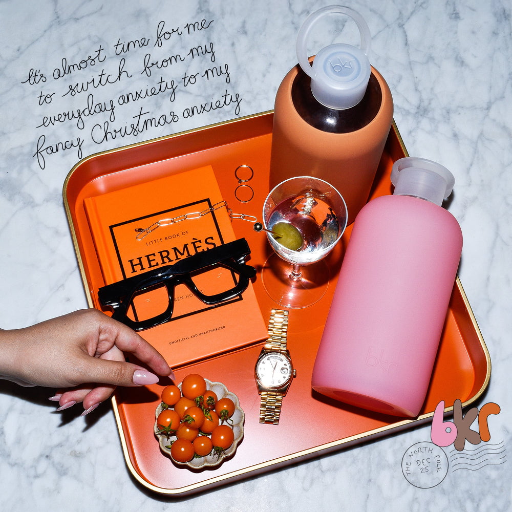 bkr reusable glass and silicone water bottles in opaque earthy ginger terracotta and sheer sugary warm pink.